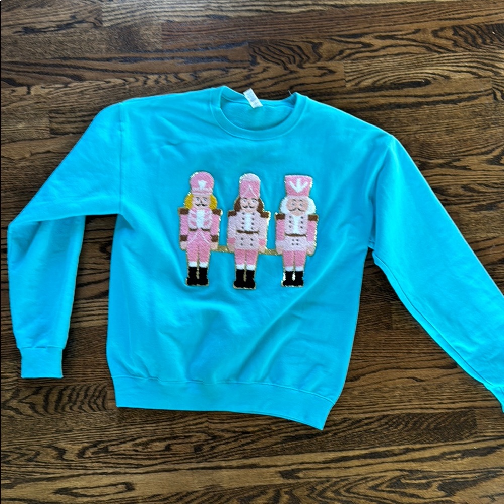 Blue Sweatshirt with Pink Nutcracker Design